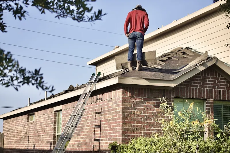 Professional roofer working on a residential roof in March Air Reserve Base